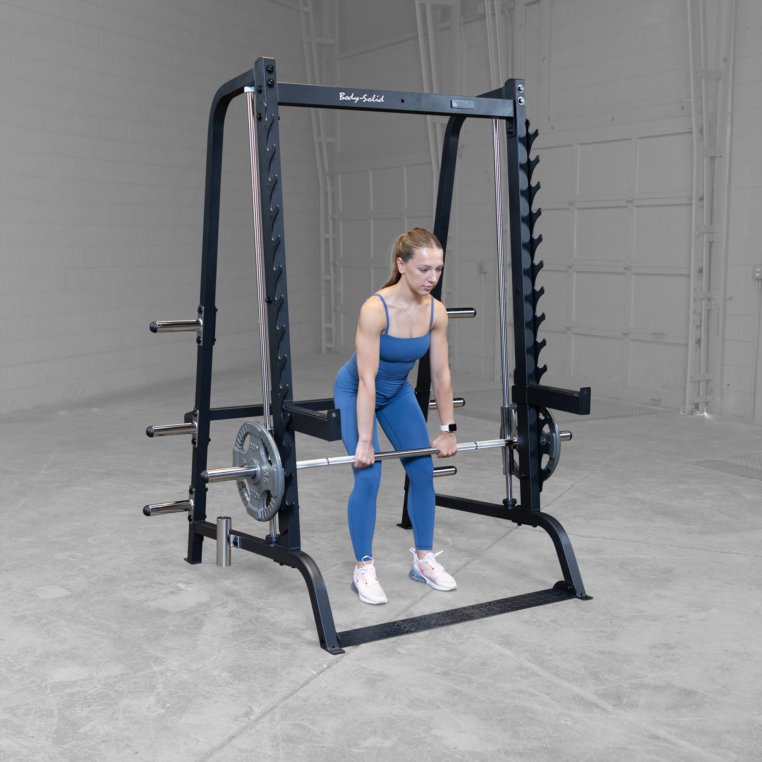 Athlete performing Smith machine deadlifts on the Body-Solid GS348B Series 7 Smith Machine using the 7° angled guided bar and Olympic weight plates