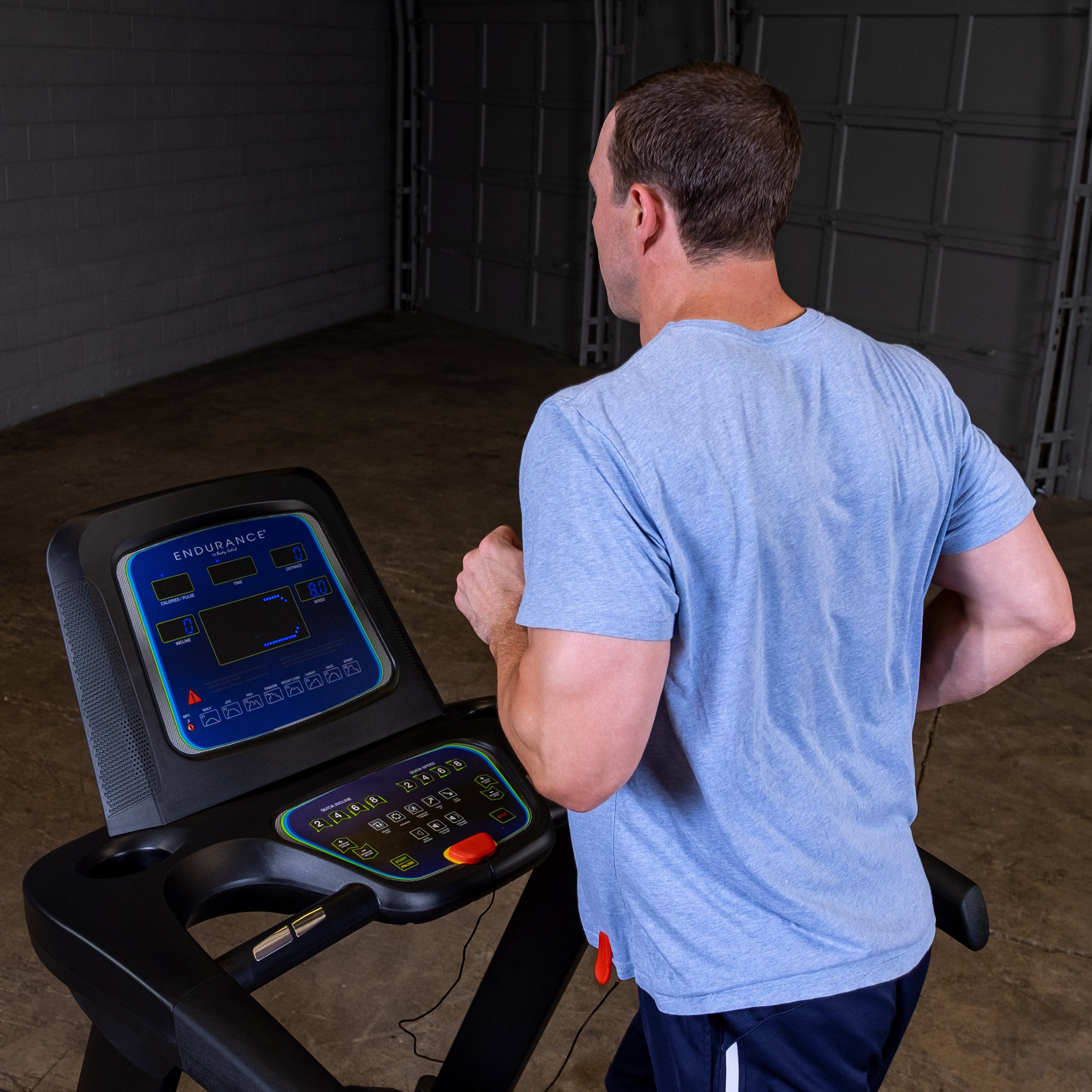Man running on Body-Solid Endurance T25 treadmill during home cardio workout