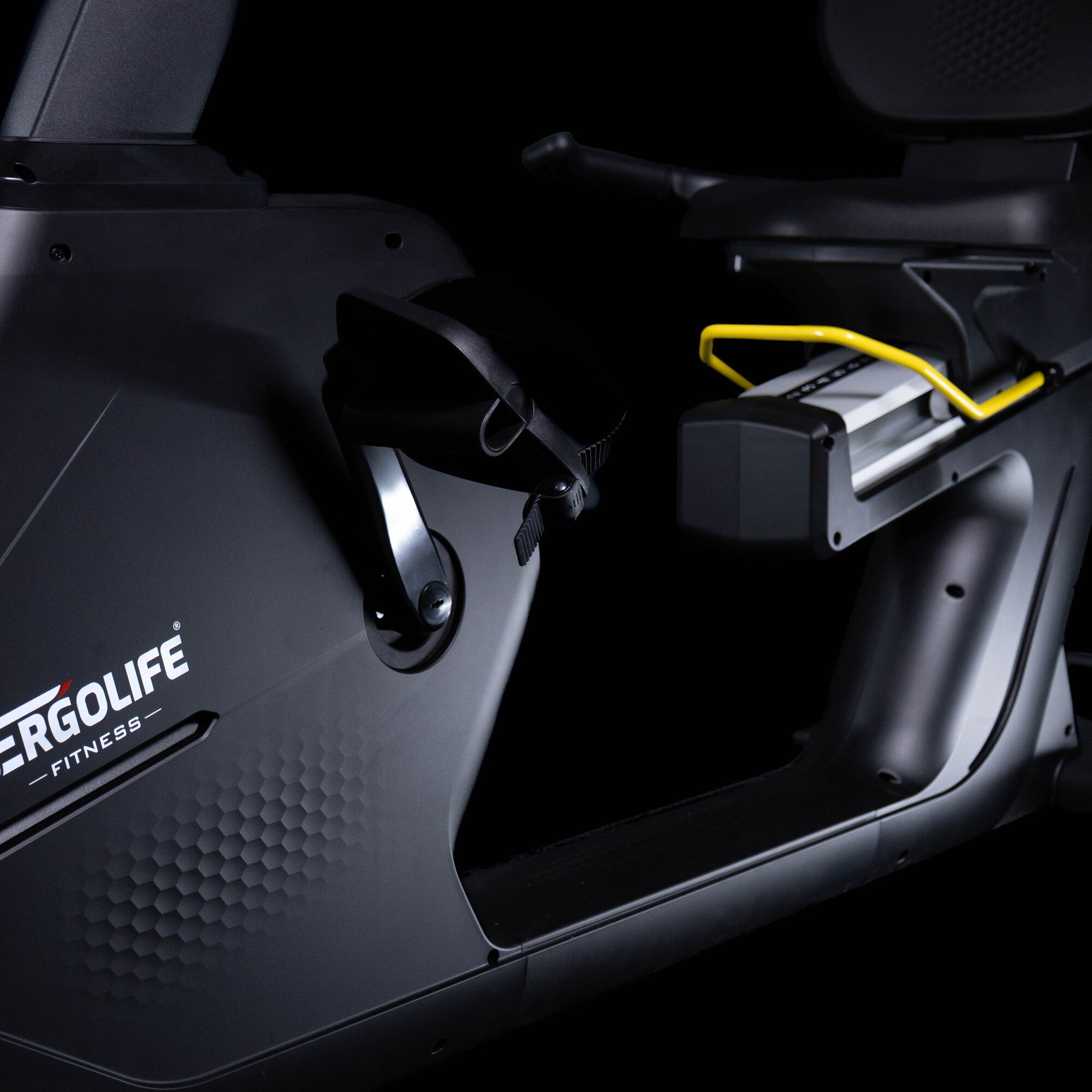 Close-up of the ERGOLIFE BR201E recumbent exercise bike seat, pedals, and step-through frame