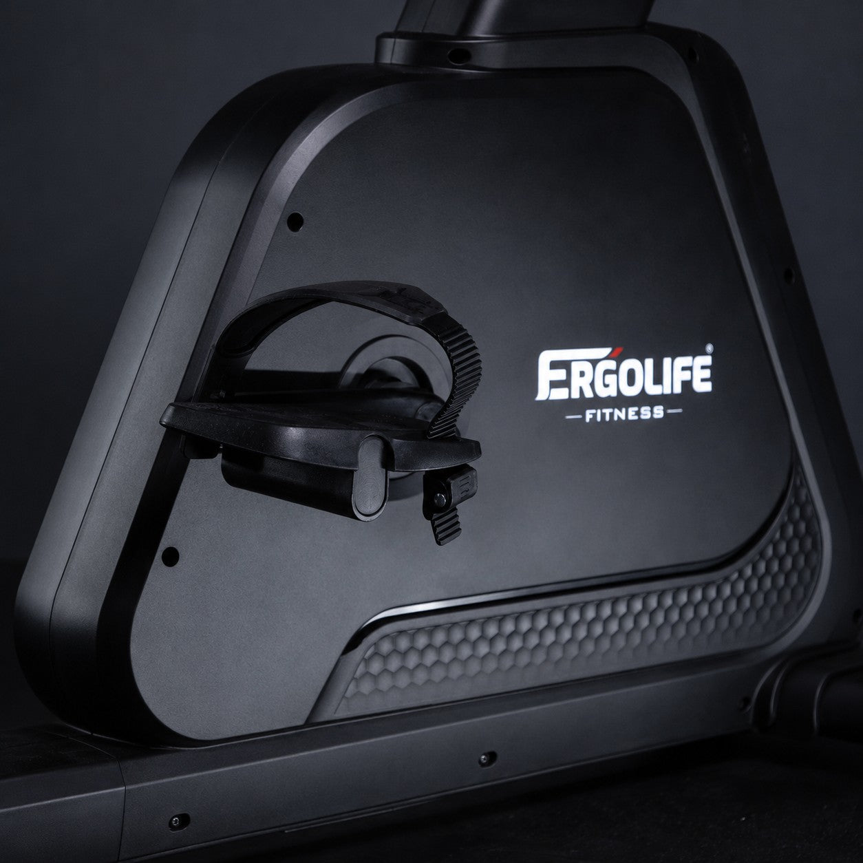 Close-up of the ERGOLIFE BU201E upright exercise bike pedal with adjustable foot strap and durable magnetic resistance drive system