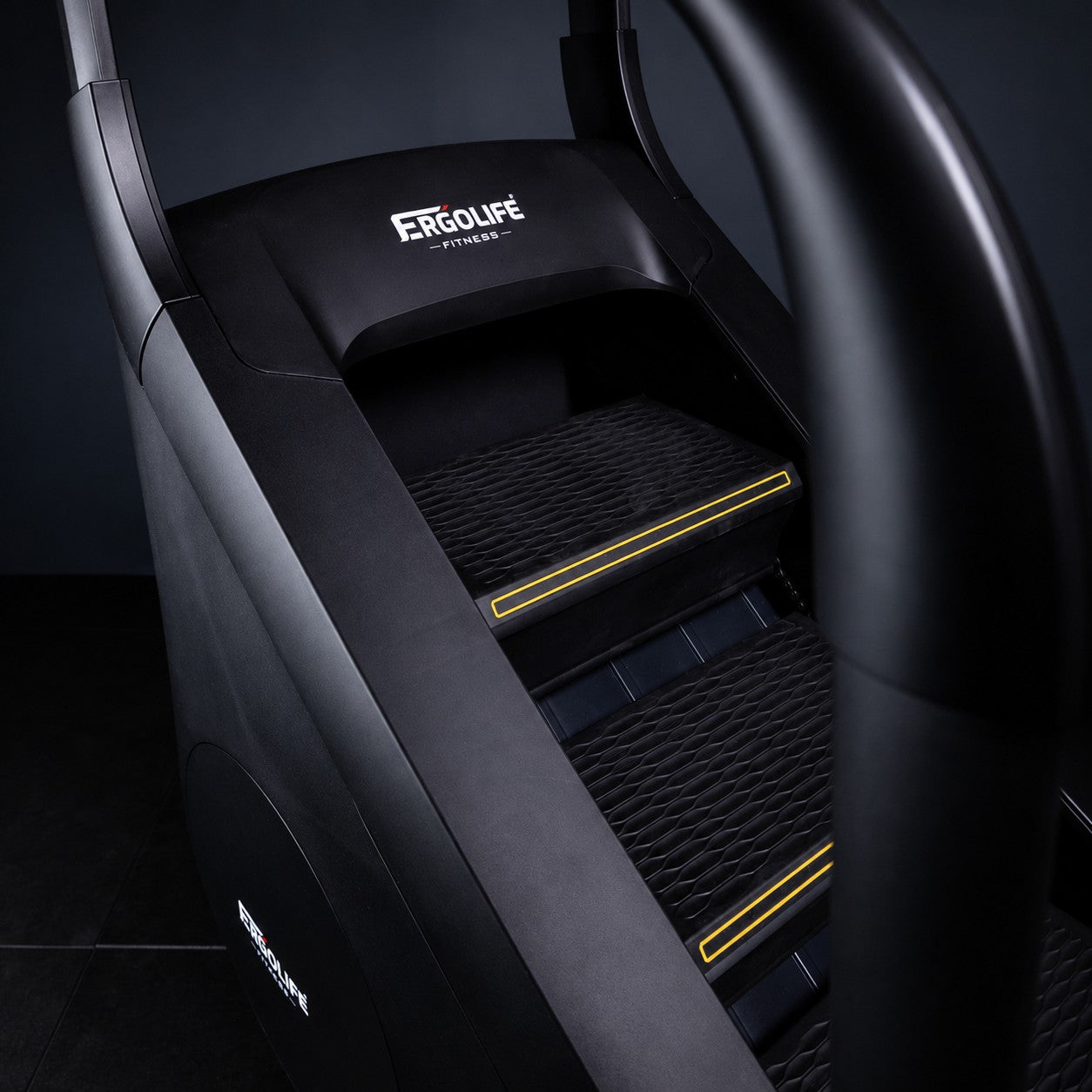 Close-up of the ERGOLIFE CS201ES adjustable resistance stair climber showing the textured non-slip steps and commercial-grade construction
