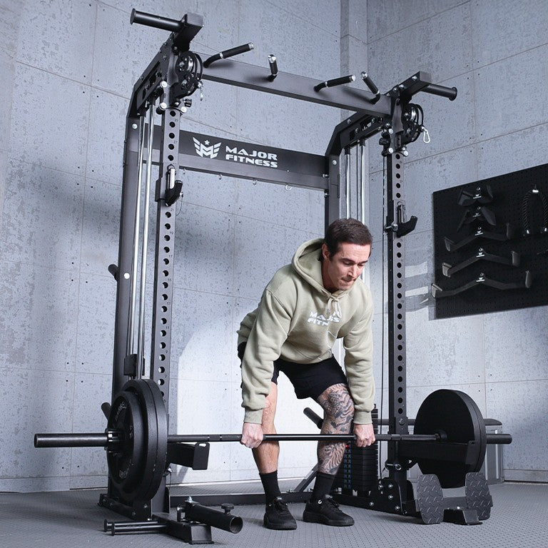 Athlete performing deadlifts in front of the Major Fitness F22 Pro all-in-one power rack home gym with dual pulley system in a modern garage gym setup