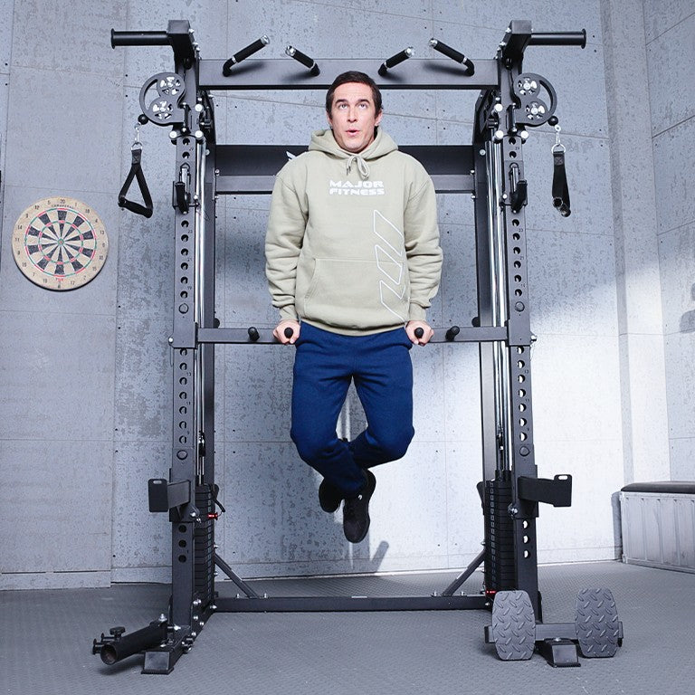 Athlete performing dip exercises on the Major Fitness F22 Pro all-in-one power rack featuring dual pulley system, multi-grip pull-up bar, and functional training attachments