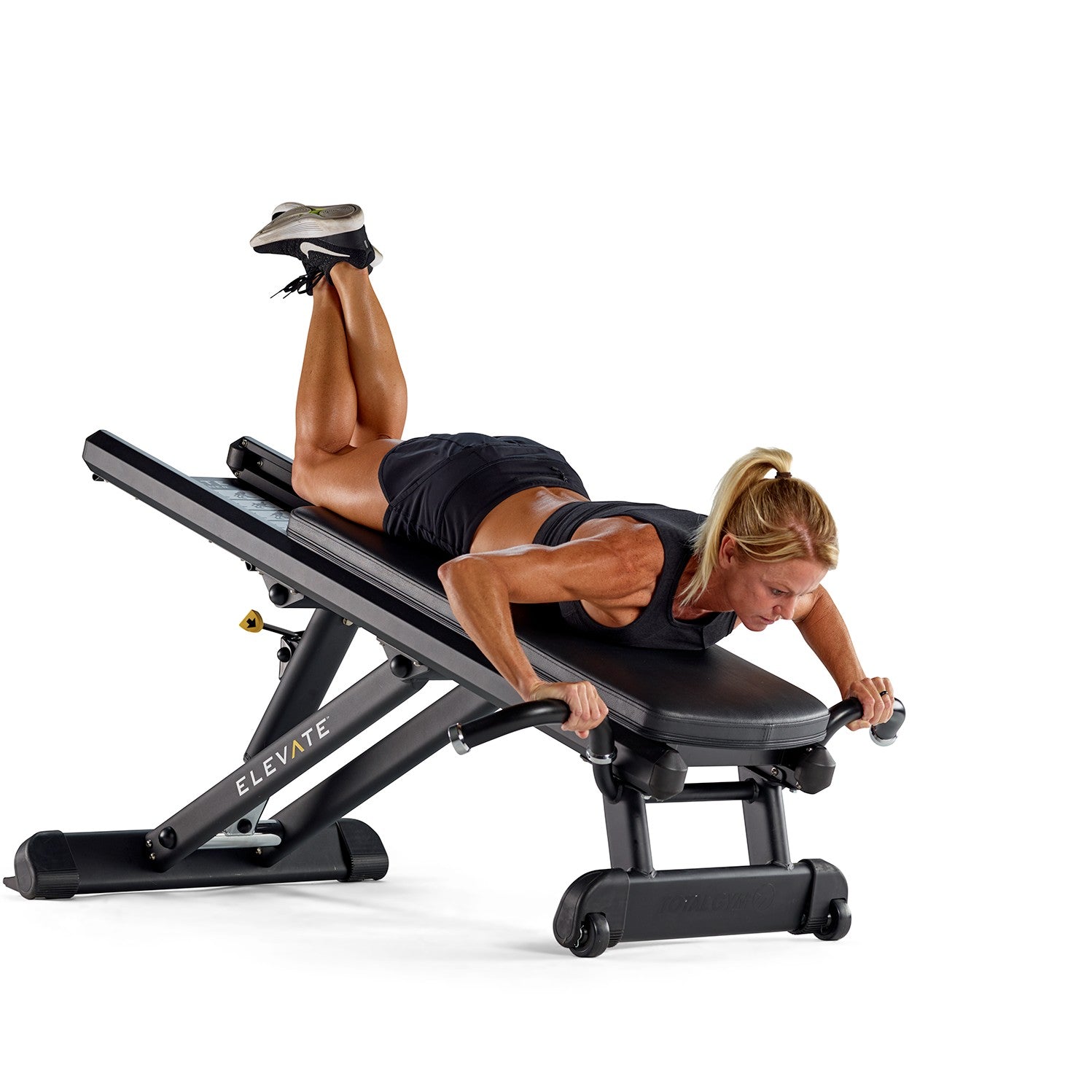 Woman using the Total Gym ELEVATE Press for upper body strength training with adjustable bodyweight resistance
