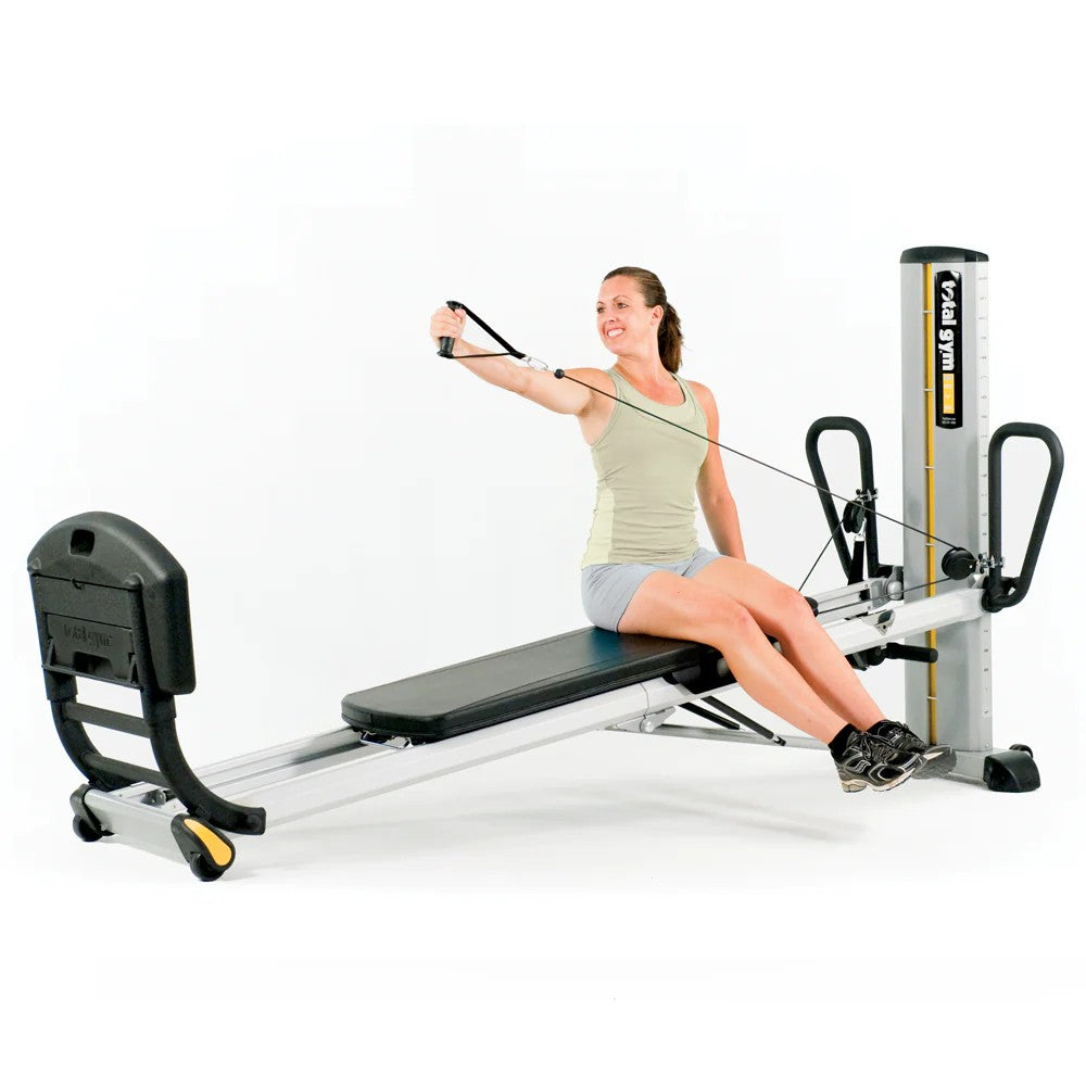 Woman using the Total Gym GTS bodyweight training system for a full body workout
