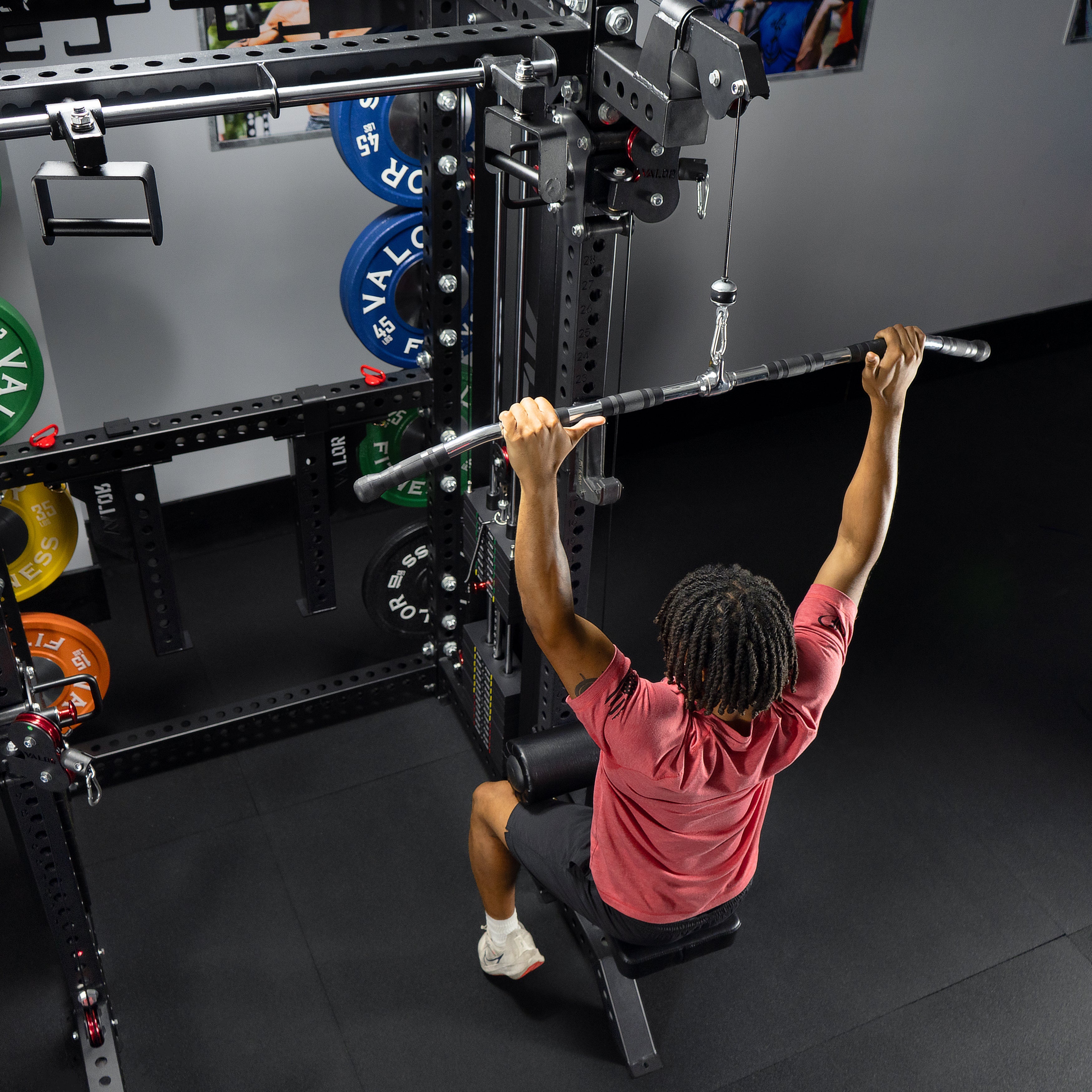 Athlete performing lat pulldown exercise on the Valor Fitness BD-83 functional trainer power rack using lat pulldown bar attachment