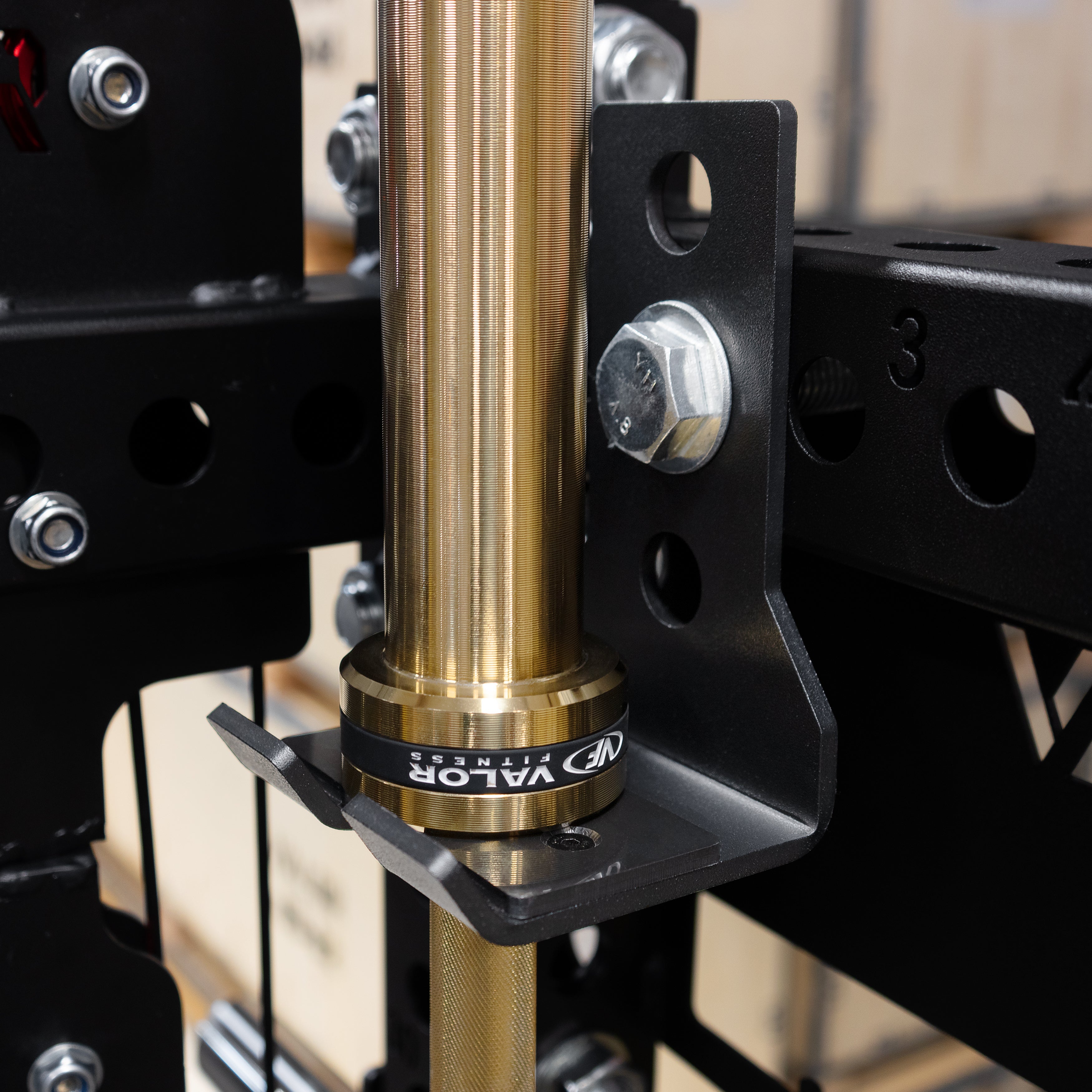 Close up view of the Valor Fitness BD-83 integrated Olympic barbell storage holder mounted to the power rack frame
